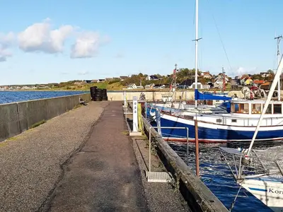 a boat is docked at a dock in the water at 4 person holiday home in Farsø-By Traum in Farsø