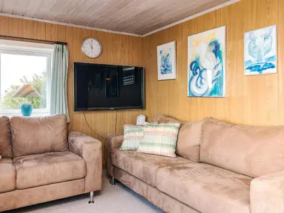 a living room with a couch and a tv at 4 person holiday home in Farsø-By Traum in Farsø