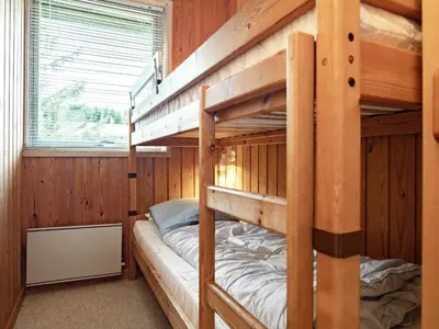 two bunk beds in a room with a window at Cozy Cottage near Blokhus - By Traum Ferienwohnungen in Blokhus