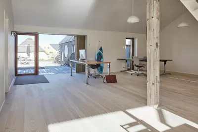 an office with a desk and a computer on a wooden floor at Vesterlandet in Vestervig