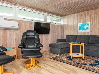 a living room with a couch and a chair at 7 person holiday home in Lemvig-By Traum in Lemvig