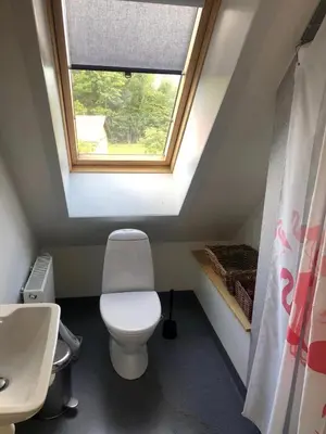 a bathroom with a toilet and a window at Istrup gammel skole in Bedsted Thy