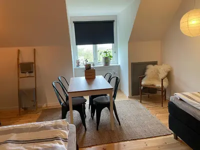 a dining room with a table and chairs and a window at Room 17 - Hawkraft kulturhotel in Vestervig