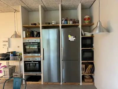 a kitchen with a stainless steel refrigerator at Room 17 - Hawkraft kulturhotel in Vestervig