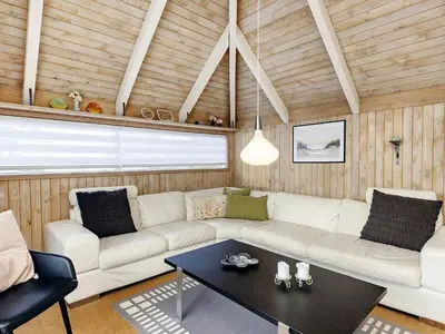 a living room with a white couch and a table at 8 person holiday home in Fjerritslev-By Traum in Fjerritslev