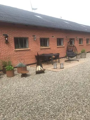 a patio in front of a brick building at Ny Roesgaard in Lemvig