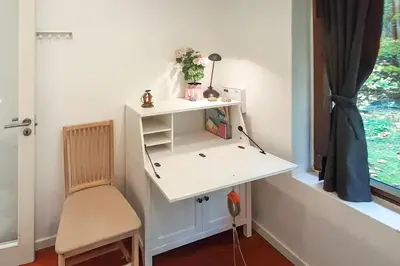 a white desk with a chair next to a window at Wellness Oase med Sauna, Fodbad og Højhastighed Internet i Naturens Fred og Ro in Nibe