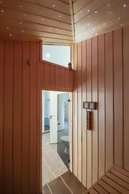 a room with wooden walls and a hallway with a window at Wellness Oase med Sauna, Fodbad og Højhastighed Internet i Naturens Fred og Ro in Nibe