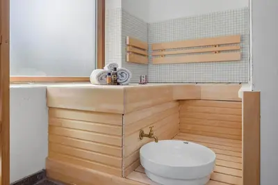 a bathroom with a white toilet and a sink at Wellness Oase med Sauna, Fodbad og Højhastighed Internet i Naturens Fred og Ro in Nibe