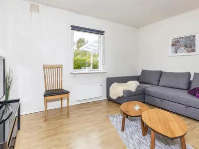 a living room with a couch and a table at 6 person holiday home in Nibe-By Traum in Nibe