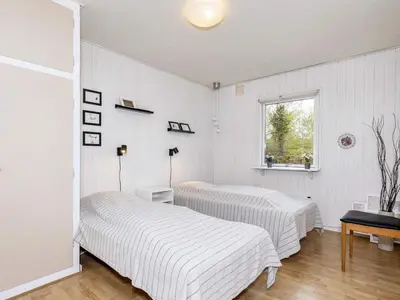 two beds in a room with white walls and a window at 6 person holiday home in Nibe-By Traum in Nibe