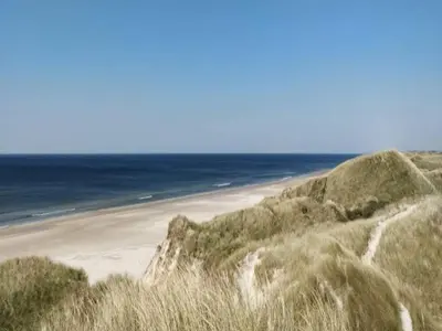 a sandy beach with the ocean in the background at 6 person holiday home in Saltum-By Traum in Saltum