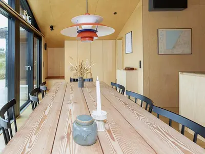a large wooden table in a room with chairs at 6 person holiday home in Saltum-By Traum in Saltum