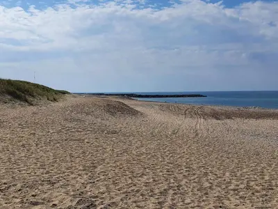 a sandy beach with the ocean in the background at 6 person holiday home in Vestervig-By Traum in Vestervig