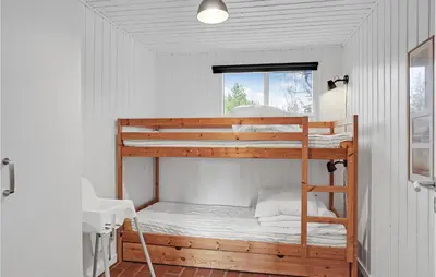 a couple of bunk beds in a room at 3 Bedroom Cozy Home In Blokhus in Blokhus