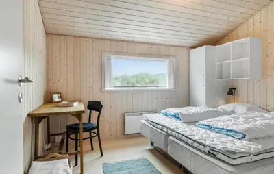 a bedroom with a bed and a desk and a window at Awesome Home In Løkken With Kitchen in Løkken