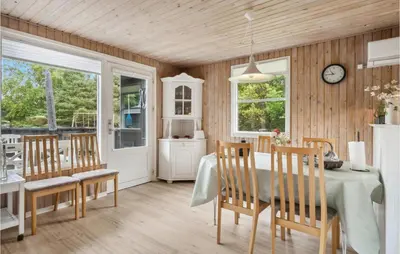 a dining room with a table and chairs at 3 Bedroom Awesome Home In Saltum in Saltum