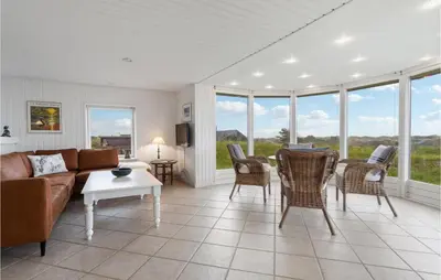 a living room with a couch and chairs and a table at Stunning Home In Blokhus in Blokhus