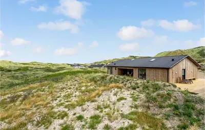 a wooden house on top of a hill at Nice Home In Løkken With Sauna in Løkken