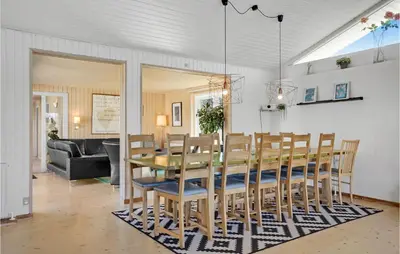 a dining room with a table and chairs at Gorgeous Home In Blokhus With Sauna in Blokhus