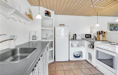 a kitchen with a sink and a refrigerator at Gorgeous Apartment In Blokhus With Wifi in Blokhus