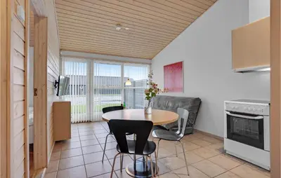 a kitchen with a table and chairs in a room at 2 Bedroom Stunning Home In Pandrup in Pandrup