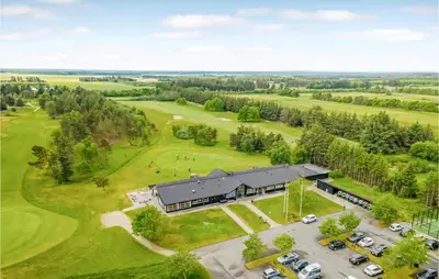 an aerial view of a building with a golf course at 2 Bedroom Lovely Home In Pandrup in Pandrup