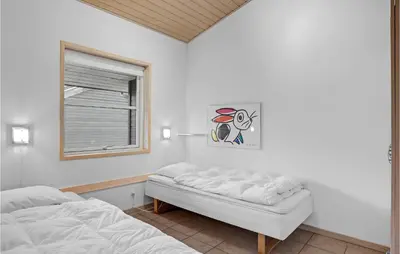 a bedroom with a bed and a window at Cozy Home In Pandrup With Wifi in Pandrup