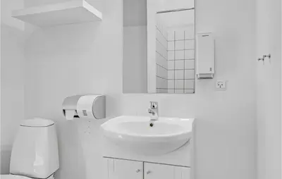 a white bathroom with a sink and a toilet at Cozy Home In Pandrup With Wifi in Pandrup