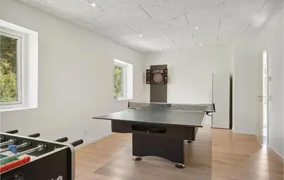 an empty room with a ping pong table in it at Stunning Home In Blokhus With Kitchen in Blokhus