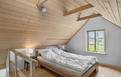 a bed in a room with a wooden ceiling at 3 Bedroom Stunning Home In Pandrup in Pandrup