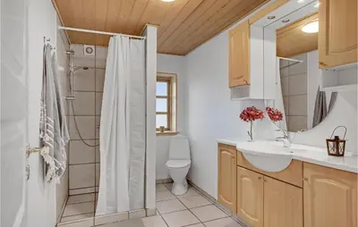 a bathroom with a shower and a sink and a toilet at 3 Bedroom Stunning Home In Pandrup in Pandrup