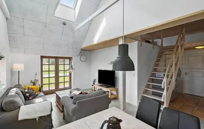 a living room with a couch and a staircase at 3 Bedroom Stunning Home In Pandrup in Pandrup