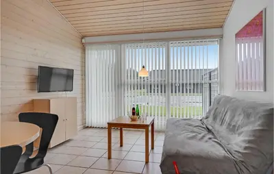 a living room with a couch and a table at 2 Bedroom Nice Home In Pandrup in Pandrup