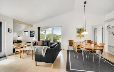 a living room with a couch and a table at Amazing Home In Brovst With Kitchen in Brovst