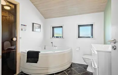 a white bathroom with a tub and a toilet at 3 Bedroom Awesome Home In Harboøre in Harboør