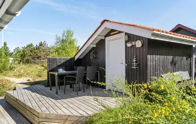 a wooden deck with a table and chairs on it at Beautiful Home In Thisted With Kitchen in Thisted