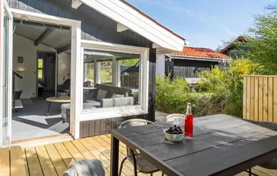 a patio with a table and chairs on a deck at Beautiful Home In Thisted With Kitchen in Thisted