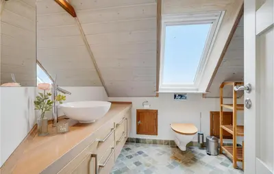 a bathroom with a sink and a window at Lovely Home In Harboøre With Sauna in Harboør