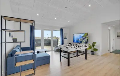 a living room with a game table and a blue couch at Lovely Home In Thisted With Sauna in Thisted