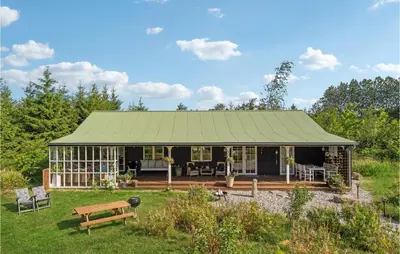 a house with a green roof in a field at 3 Bedroom Cozy Home In Vemb in Vemb