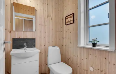 a bathroom with a toilet and a sink and a window at 3 Bedroom Cozy Home In Vemb in Vemb