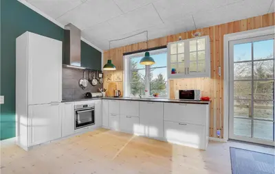 a kitchen with white cabinets and a large window at 3 Bedroom Cozy Home In Vemb in Vemb