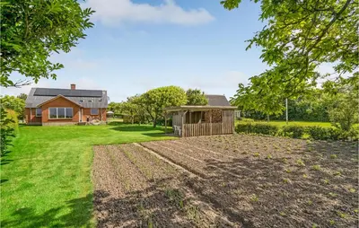 a large yard with a house in the background at Awesome Home In Vestervig With Wifi in Vestervig