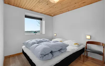 a large bed in a room with a window at Awesome Home In Vestervig With Wifi in Vestervig