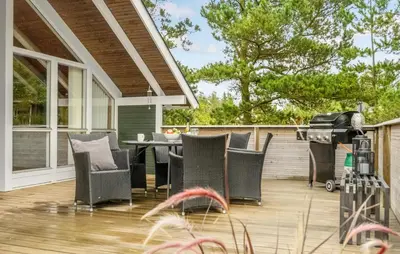 a patio with a table and chairs and a grill at Beautiful Home In Thisted With Kitchen in Thisted
