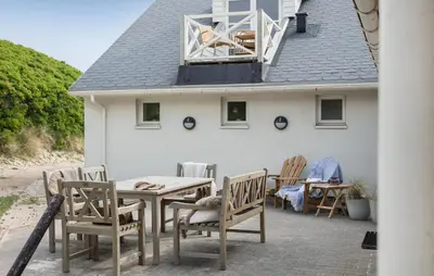 a patio with chairs and a table and a house at Gorgeous Home In Lemvig With Sauna in Lemvig