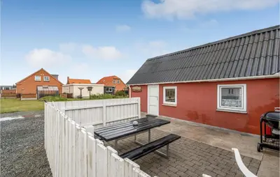 a backyard with a picnic table and a building at Lovely Home In Thisted With Kitchen in Thisted