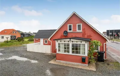 a red house sitting on the side of a road at Lovely Home In Thisted With Kitchen in Thisted