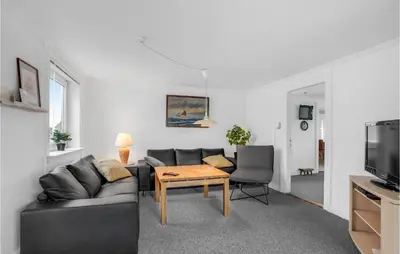 a living room with a couch and a table at Lovely Home In Thisted With Kitchen in Thisted